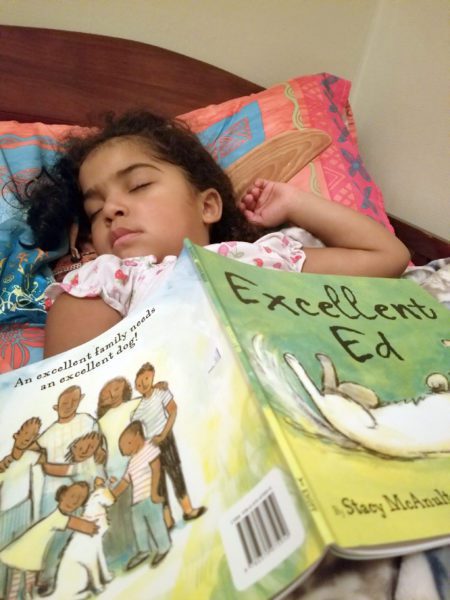 A child sleeping beneath a picture book