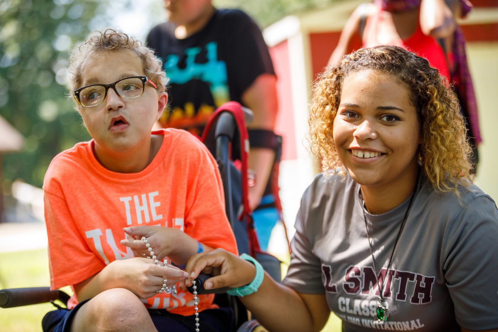 Two individuals smile at Camp Millhouse