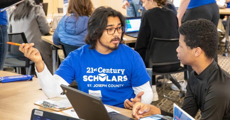 A 21st Century Fellow helps a student at Success Fest