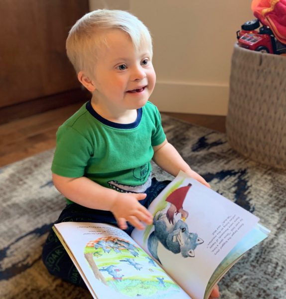 A child happily reads a book