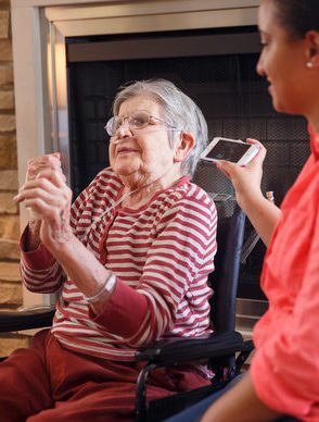An older woman participates in music therapy